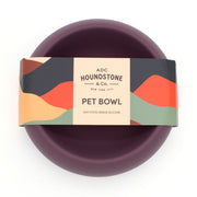 top down view of houndstone coquito silicone dog food bowl in plum with houndstone packaging