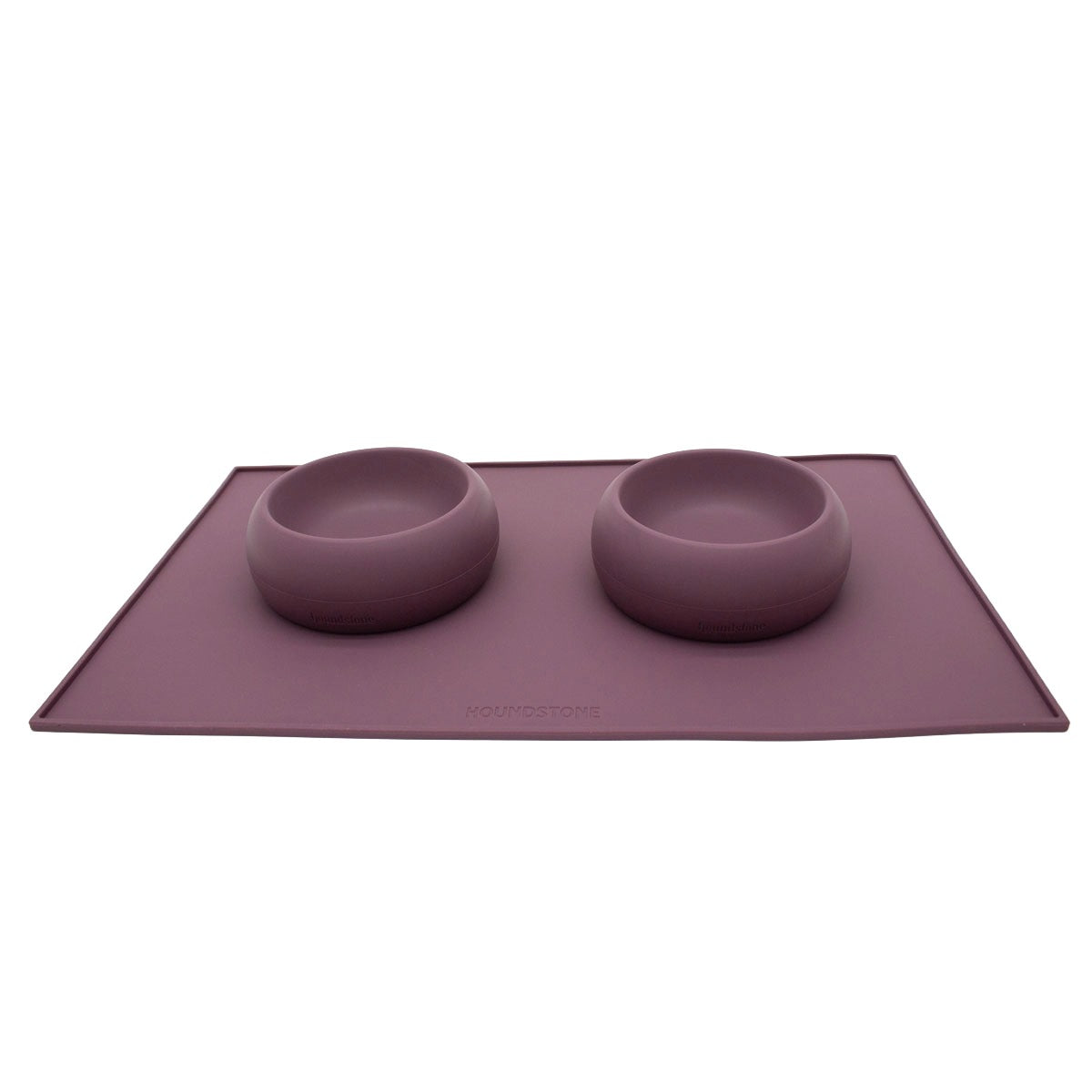 two  houndstone coquito silicone dog food bowls on a dog food mat all in plum color