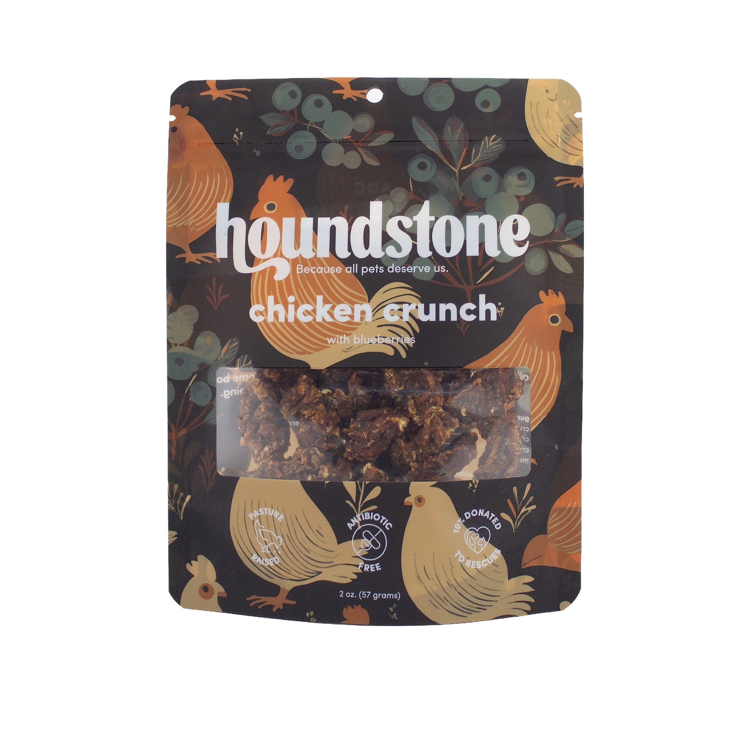 A package of Houndstone Chicken Crunch dehydrated dog treats on a plain white background. The packaging features a dark background decorated with illustrations of chickens and blueberries, with a clear window in the center showing the dog treats inside.