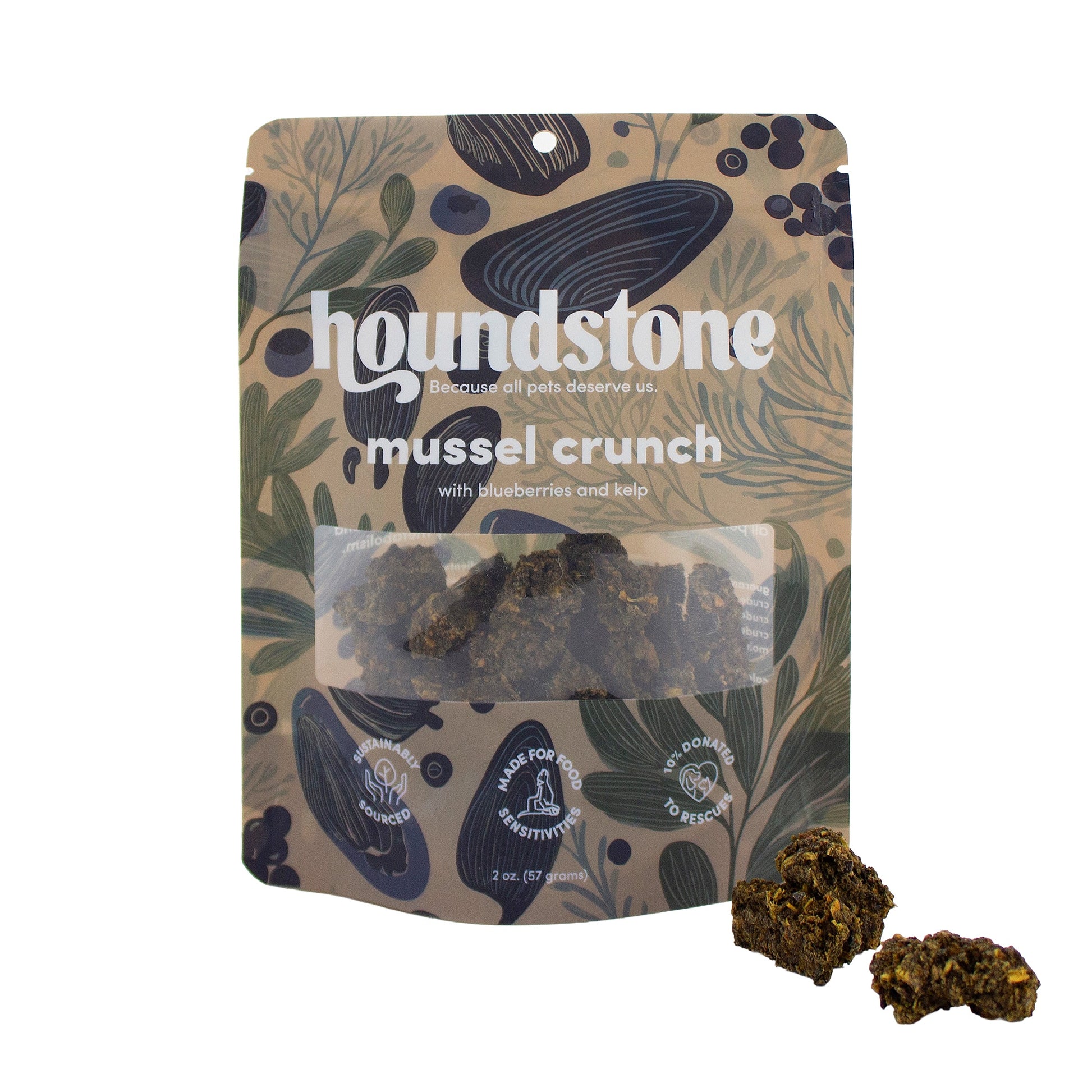 A stand-up pouch of Houndstone Mussel Crunch dehydrated dog treats on a white background, with two pieces of the dehydrated dog treats placed in front of the package.