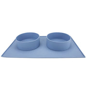 two houndstone pony silicone dog bowls in blue on a dog food mat