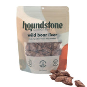 A stand-up pouch of Houndstone Wild Boar Liver single ingredient freeze dried dog treats, with several pieces of the brown dog treats scattered in front on a white background.