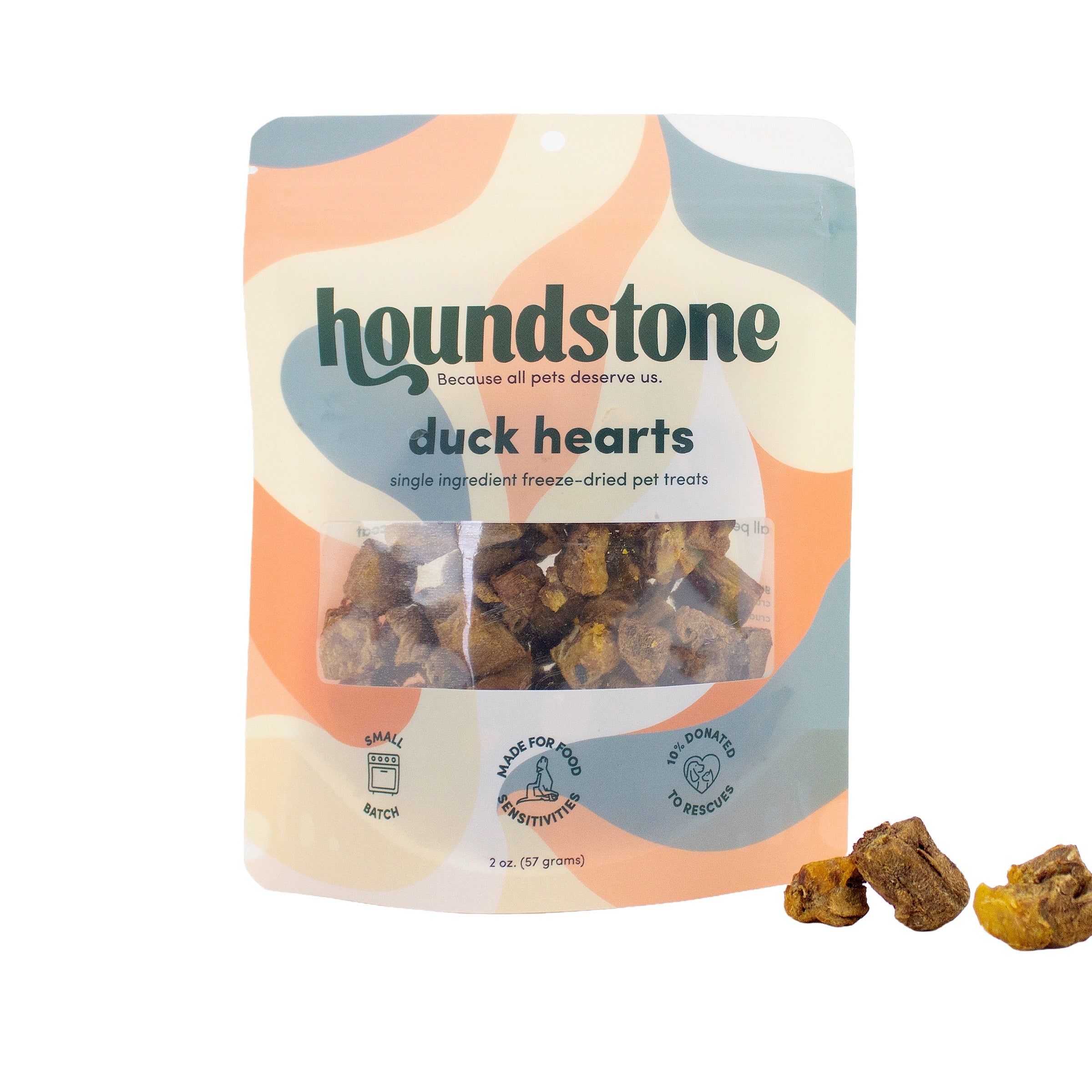 A package of Houndstone Duck Hearts single-ingredient freeze-dried dog treats, shown on a white background with three dog treats placed in front of the bag.
