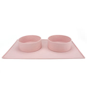 Houndstone silicone dog bowl mat in pink with 2 silicone dog food bowls on top 