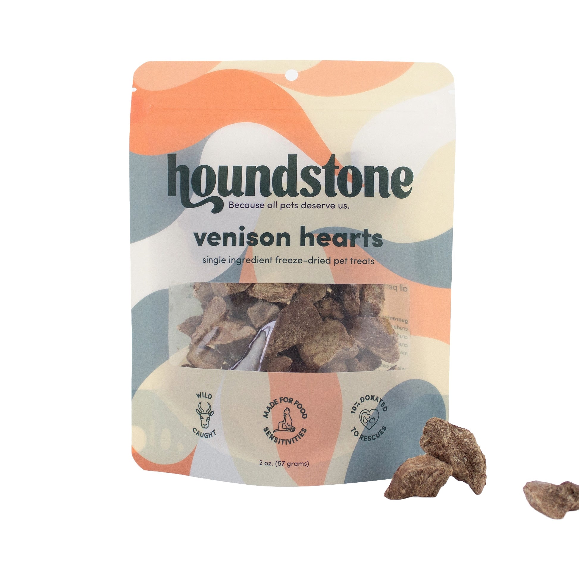 A package of Houndstone Venison Hearts freeze dried dog treats on a white background, with three freeze dried dog treats displayed outside the package to the right.
