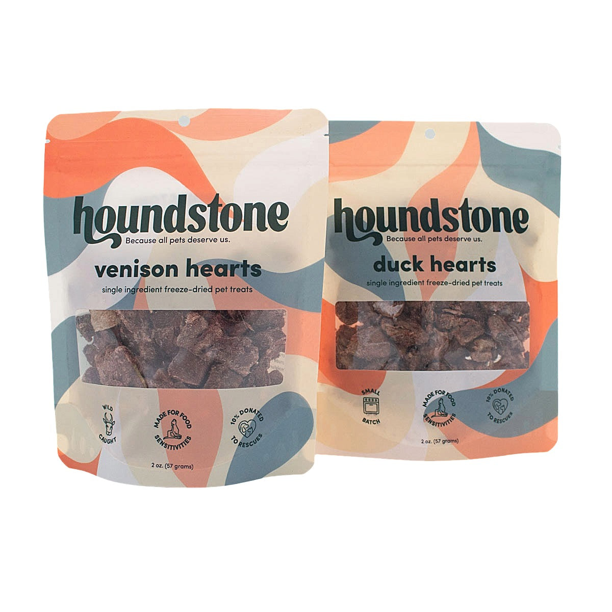 Two Houndstone dog treat pouches on a white background: one labeled venison hearts freeze dried dog treats and one labeled duck hearts freeze dried dog treats. The packaging has a colorful abstract design in orange, cream, and blue-gray, with a clear window showing the freeze dried dog treats inside.
